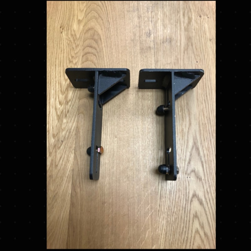 Eezi awning k9 load bar mount pair in black metal top side view on wooden surface