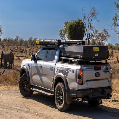 Eezi awn ford ranger roof rack on truck parked on dirt road back left view in desert
