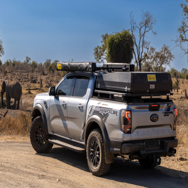 Eezi awn ford ranger roof rack on truck parked on dirt road back left view in desert