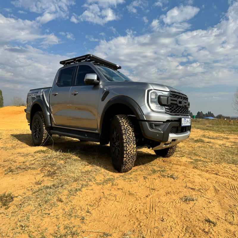 Eezi awn ford ranger roof rack front left view on truck parked outside in field