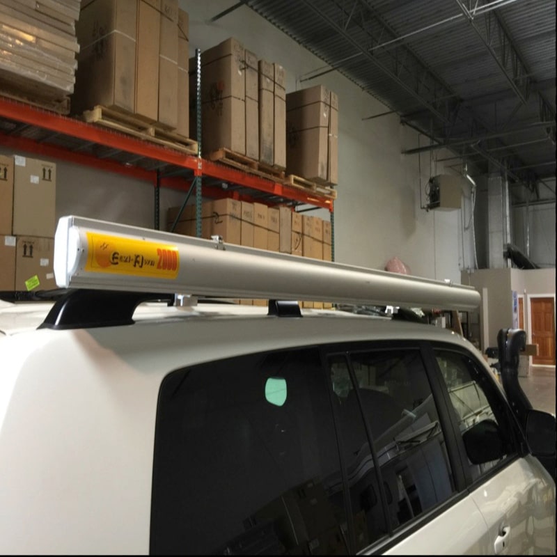 Eezi awning brackets for roof rails series 2000 with mount on suv bar front side view in warehouse