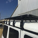 Eezi awn k9 automobile roof racks close up on mercedes g wagon with brackets left front angle view next to warehouse