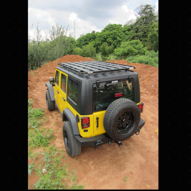 Eezi awn k9 roof rack for roof rails on yellow jeep left rear view outside