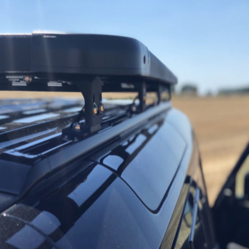 Eezi awn land rover defender roof rack on black suv close up height from roof back right view looking forward