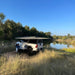Eezi dragonfly 180 awning front left view open outside on truck in swamp with woman