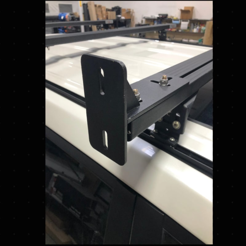 Eezi k9 load bar mount overlanding bracket in black metal top left view on suv in garage