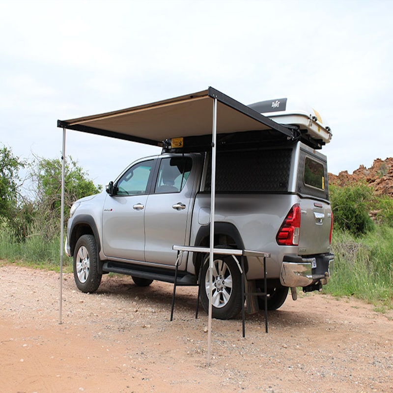 Eez swift awning front left view open set up outside with table and truck