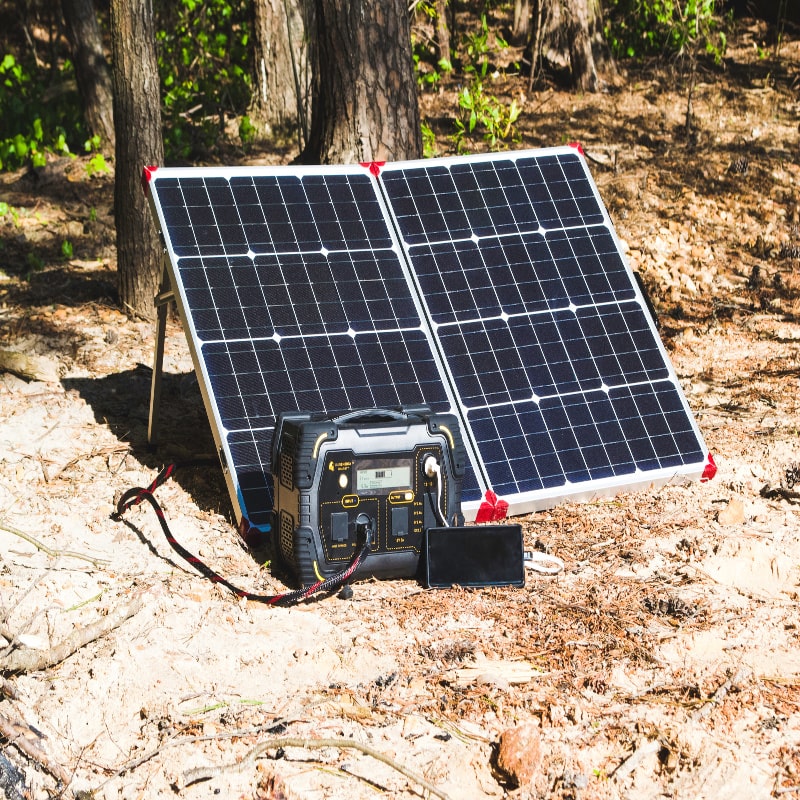 Lion safari portable generator plugged in with foldable solar panel at beach on sand