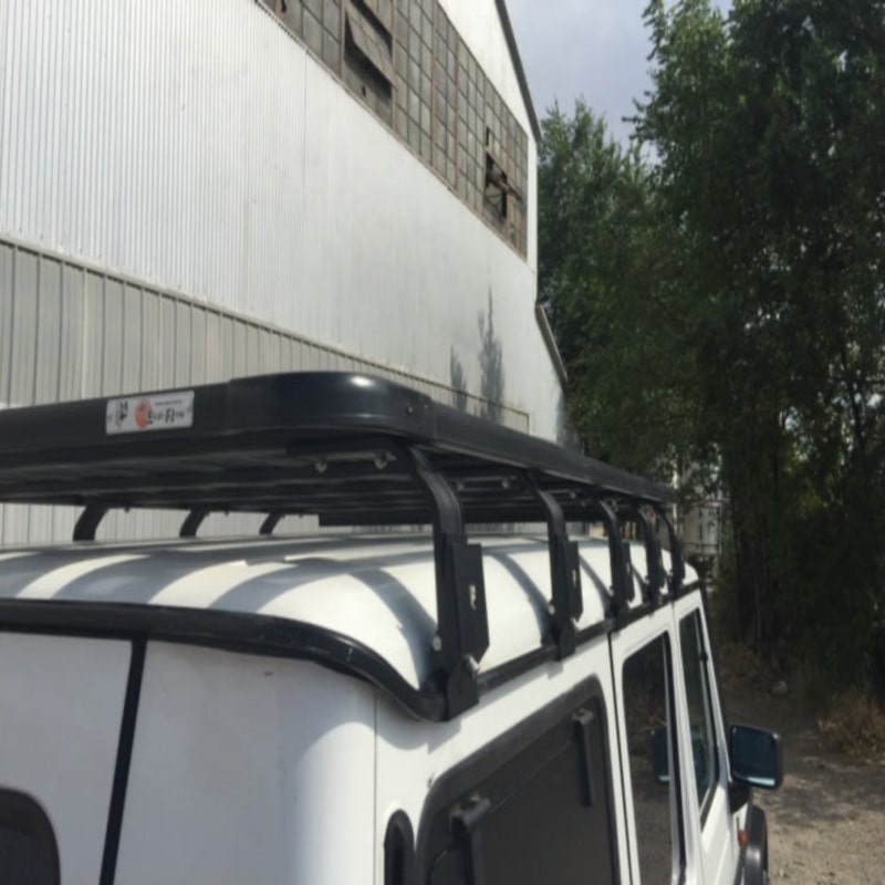 eezi awn mercedes g wagon roof rack on white suv rear right view next to warehouse